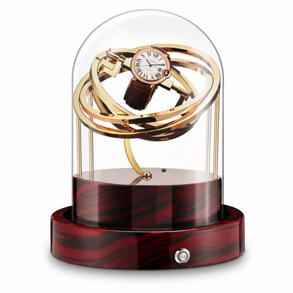 Remontoir automatique Astronome Prestige doré sous cloche en verre avec socle en bois rouge et noir.