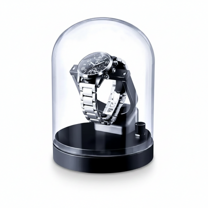 Remontoir automatique gris sous cloche en verre pour une montre, design compact et élégant avec base circulaire.