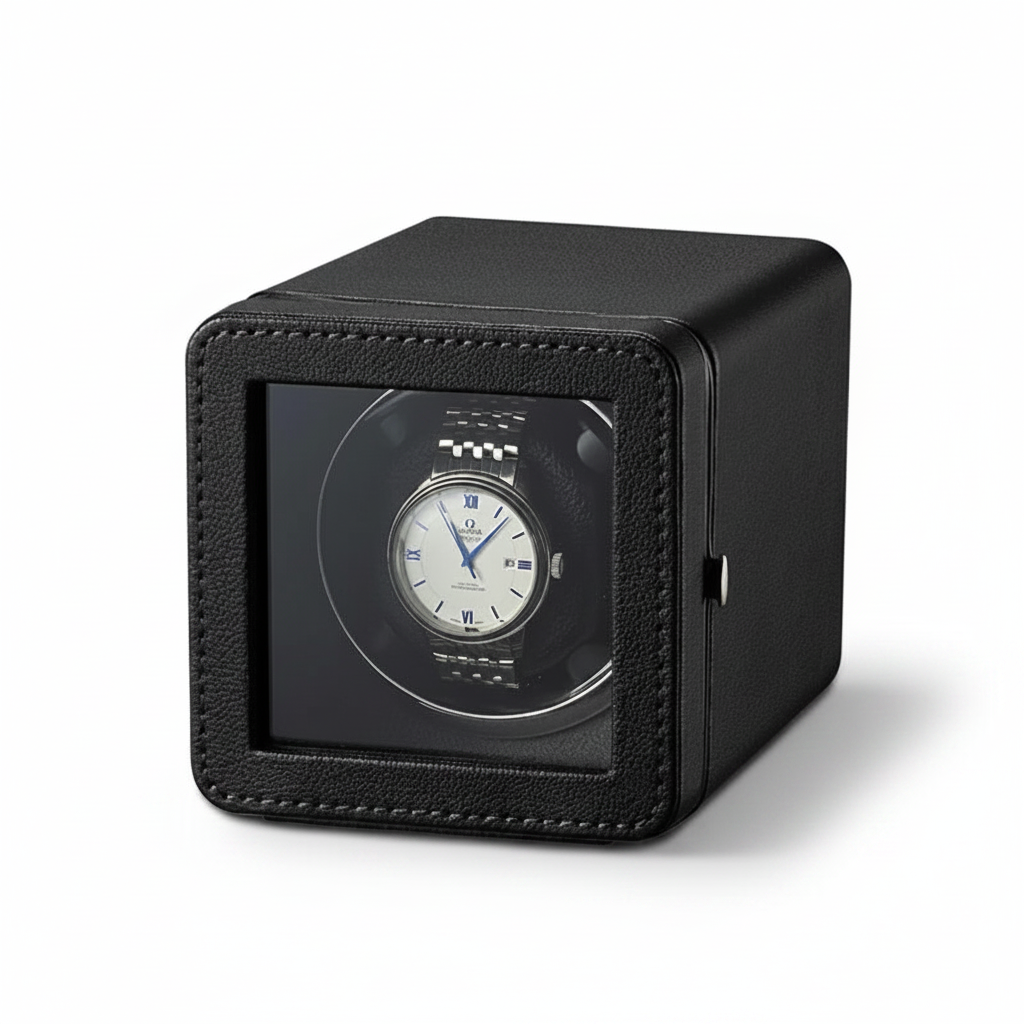 Remontoir de montre automatique noir en forme de cube avec finition texturée et fenêtre de visualisation transparente.